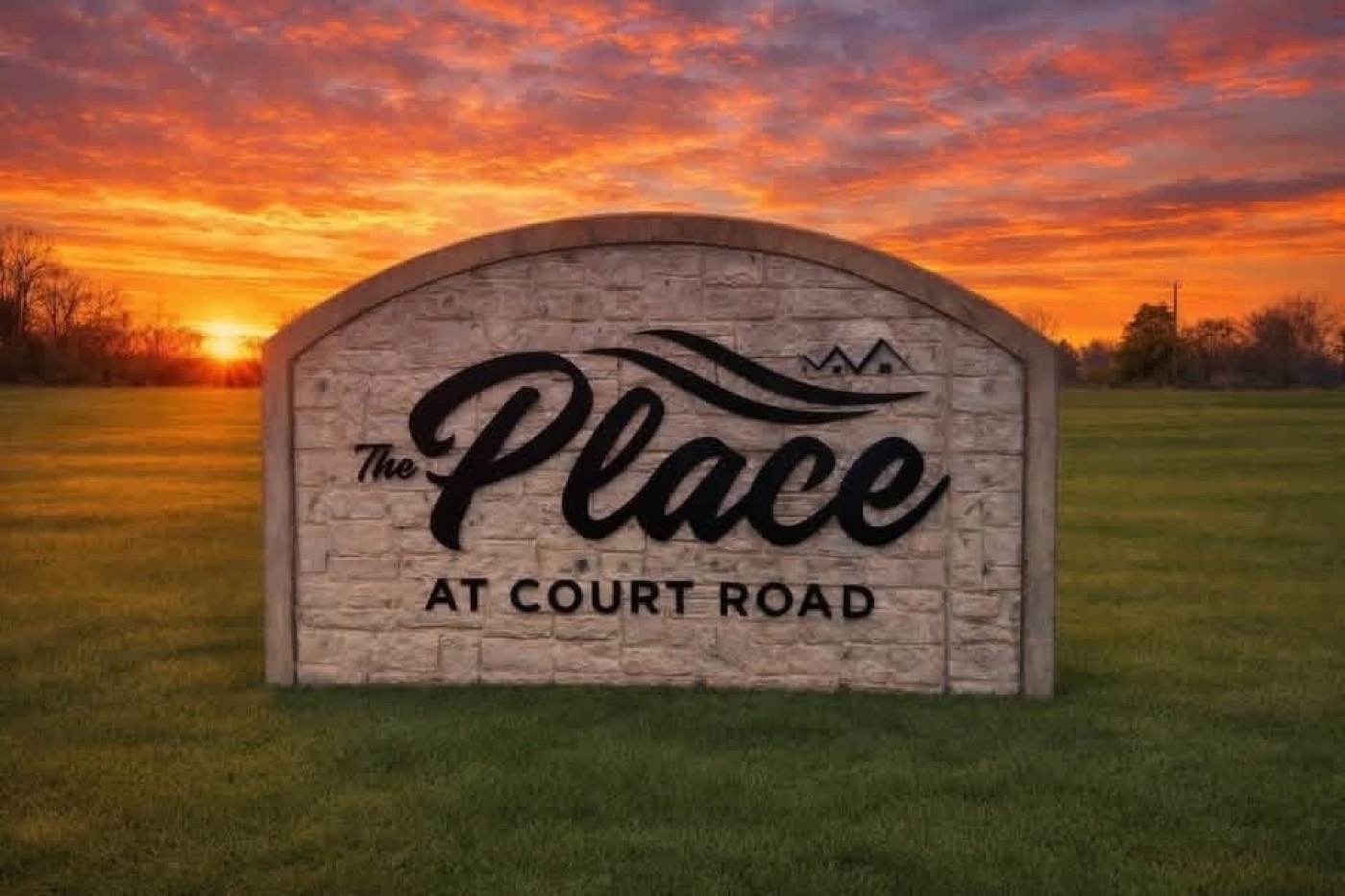 The Place at Court Road — community entrance sign at sunset