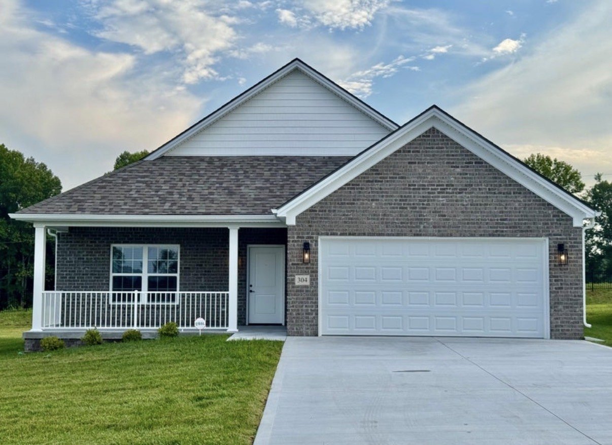 All-brick home with covered front porch at The Place at Court Road