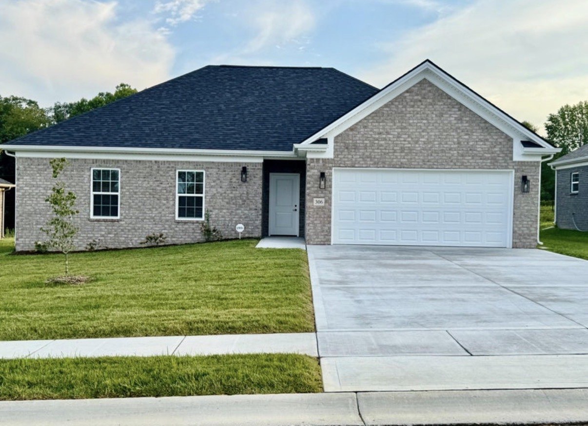 All-brick home with sidewalk and sodded yard at The Place at Court Road