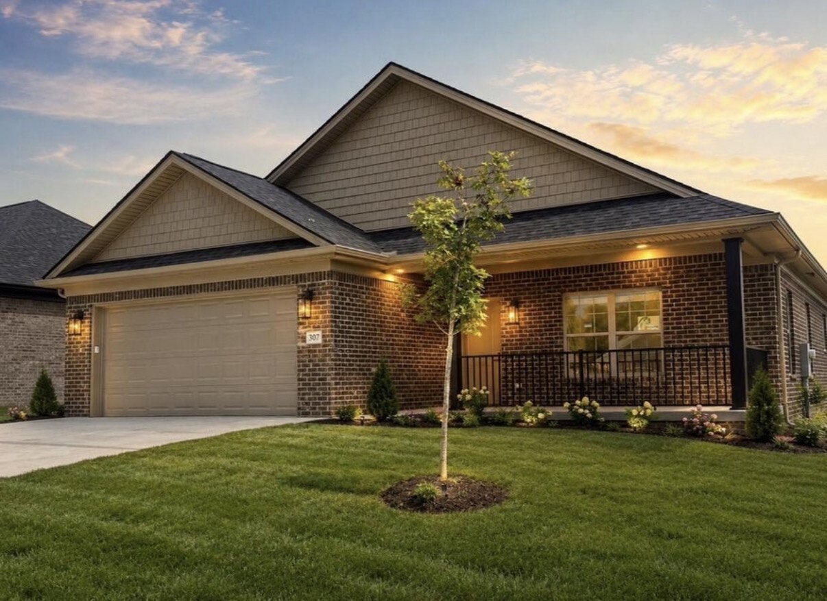 All-brick home with covered porch at sunset at The Place at Court Road